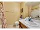 This bathroom features a white sink, toilet, and mirror with floral shower curtains at 6549 Clara Bow Ave # 103, Las Vegas, NV 89122