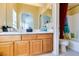 Well-lit bathroom featuring double sinks, granite countertops, and a bathtub with a shower at 6549 Clara Bow Ave # 103, Las Vegas, NV 89122