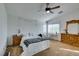 Bright bedroom featuring a ceiling fan, neutral walls, a large window, and wood furniture at 6549 Clara Bow Ave # 103, Las Vegas, NV 89122