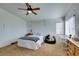 Bright bedroom featuring a ceiling fan, neutral walls, a large window, and wood furniture at 6549 Clara Bow Ave # 103, Las Vegas, NV 89122