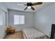 Bedroom features a ceiling fan, a window with blinds, light walls, and carpet floors at 6549 Clara Bow Ave # 103, Las Vegas, NV 89122