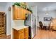This kitchen features wooden cabinets, stainless steel refrigerator, and wood style floors at 6549 Clara Bow Ave # 103, Las Vegas, NV 89122