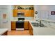 Functional kitchen featuring wood cabinets, white countertops, and stainless steel appliances at 6549 Clara Bow Ave # 103, Las Vegas, NV 89122