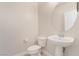 Bathroom featuring a pedestal sink, modern fixtures, and toilet at 7083 Seat Wall Rd, Las Vegas, NV 89148