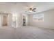 Bedroom features ceiling fan, carpet, staircase and large window at 7083 Seat Wall Rd, Las Vegas, NV 89148