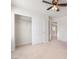 Bedroom featuring neutral carpet, a ceiling fan, and a closet with sliding doors at 7083 Seat Wall Rd, Las Vegas, NV 89148