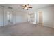 Bedroom features carpet, ceiling fan, staircase and white trim at 7083 Seat Wall Rd, Las Vegas, NV 89148
