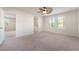 Bedroom featuring carpet, ceiling fan, large windows and archway to bathroom at 7083 Seat Wall Rd, Las Vegas, NV 89148