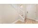 Inviting entryway featuring a white door and staircase with light wood flooring and neutral walls at 7083 Seat Wall Rd, Las Vegas, NV 89148