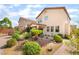 Charming home showcasing a meticulously landscaped front yard featuring decorative rocks and lush shrubbery at 7083 Seat Wall Rd, Las Vegas, NV 89148