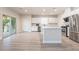 Bright kitchen features an island, stainless steel appliances and white cabinets at 7083 Seat Wall Rd, Las Vegas, NV 89148
