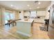 Modern kitchen featuring a center island, stainless steel appliances, and an adjacent dining area with outdoor access at 7083 Seat Wall Rd, Las Vegas, NV 89148