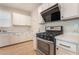 Modern kitchen showcasing stainless steel range and white cabinets with contemporary hardware at 7083 Seat Wall Rd, Las Vegas, NV 89148