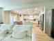 Bright living room with comfortable white sofa, flowing into dining area and kitchen with stainless steel appliances at 7083 Seat Wall Rd, Las Vegas, NV 89148