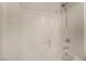Shower-tub combo featuring a white tile surround with convenient shower caddy at 7083 Seat Wall Rd, Las Vegas, NV 89148