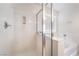 Bright shower featuring a glass enclosure and marble-look surround with convenient shower caddy at 7083 Seat Wall Rd, Las Vegas, NV 89148