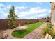 Backyard featuring artificial turf, brick pavers, hardscape and landscape at 7107 Calvert Cliffs St, North Las Vegas, NV 89084