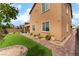 Backyard with artificial turf, brick pavers, and lush landscaping at 7107 Calvert Cliffs St, North Las Vegas, NV 89084
