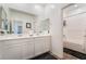 Bright bathroom with a dual sink vanity and a separate tub and shower at 7107 Calvert Cliffs St, North Las Vegas, NV 89084