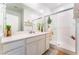 Bright bathroom featuring a double-sink vanity, walk-in shower, and neutral color palette at 7107 Calvert Cliffs St, North Las Vegas, NV 89084