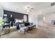 Bright bedroom features a stylish accent wall, ceiling fan and cozy sitting area at 7107 Calvert Cliffs St, North Las Vegas, NV 89084