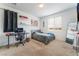 Well-lit bedroom with a modern desk and cozy bed with view at 7107 Calvert Cliffs St, North Las Vegas, NV 89084