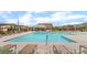 Community pool with lounge chairs and covered seating areas at 7107 Calvert Cliffs St, North Las Vegas, NV 89084