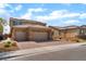 Charming two-story home with a three car garage, desert landscaping, and blue window shutters at 7107 Calvert Cliffs St, North Las Vegas, NV 89084
