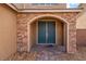 Inviting entryway featuring a beautiful stone archway and a modern, dual door entrance at 7107 Calvert Cliffs St, North Las Vegas, NV 89084