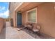Inviting front porch with seating area and a charming, paved entrance at 7107 Calvert Cliffs St, North Las Vegas, NV 89084