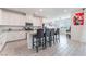 Bright kitchen featuring white cabinets, granite countertops, a central island with seating, and stainless steel appliances at 7107 Calvert Cliffs St, North Las Vegas, NV 89084