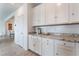 Kitchen features white cabinets, granite countertops and adjacent breakfast area, perfect for casual dining at 7107 Calvert Cliffs St, North Las Vegas, NV 89084