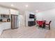 Modern kitchen and dining area featuring stainless steel appliances and a dining table at 7107 Calvert Cliffs St, North Las Vegas, NV 89084