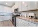 Kitchen boasts white cabinetry, granite countertops, and modern appliances including a stainless steel gas range at 7107 Calvert Cliffs St, North Las Vegas, NV 89084