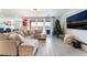 Cozy living room featuring an oversized sectional sofa, a Christmas tree, and patio views at 7107 Calvert Cliffs St, North Las Vegas, NV 89084