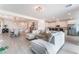 Expansive living space with a sectional sofa, wood-look flooring, and an open floor plan at 7107 Calvert Cliffs St, North Las Vegas, NV 89084