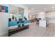 Open floor plan showcases a living room adjacent to kitchen with white cabinets and granite countertops at 7107 Calvert Cliffs St, North Las Vegas, NV 89084