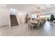 Open-concept living area featuring neutral tones, a staircase, and light wood-look flooring at 7107 Calvert Cliffs St, North Las Vegas, NV 89084
