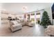 Relaxing living room with a large sofa, sliding glass doors, and wood-look tile flooring at 7107 Calvert Cliffs St, North Las Vegas, NV 89084