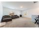 Spacious loft area featuring neutral carpet, two couches and natural light from two windows at 7107 Calvert Cliffs St, North Las Vegas, NV 89084