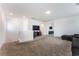 Upstairs loft area featuring neutral carpet, a television, and access to other living spaces at 7107 Calvert Cliffs St, North Las Vegas, NV 89084