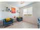 Bright sitting room with two accent chairs, modern decor and natural light from large window at 7107 Calvert Cliffs St, North Las Vegas, NV 89084