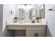 Modern bathroom with dual mirrors, white countertop, and sleek cabinets at 745 N Royal Crest Cir # 141, Las Vegas, NV 89169