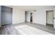 Spacious bedroom featuring gray laminate floors, large closets, and ensuite bathroom at 745 N Royal Crest Cir # 141, Las Vegas, NV 89169
