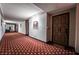 Hallway with patterned carpeting that leads to unit door at 745 N Royal Crest Cir # 141, Las Vegas, NV 89169