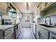 Stylish kitchen featuring gray cabinets, stainless steel appliances, and gray wood floors at 745 N Royal Crest Cir # 141, Las Vegas, NV 89169