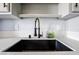 Modern kitchen sink features a black basin, stylish faucet, and bright countertops at 745 N Royal Crest Cir # 141, Las Vegas, NV 89169