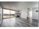 Bright living room featuring a stone fireplace, large windows with city views, and stylish gray wood flooring at 745 N Royal Crest Cir # 141, Las Vegas, NV 89169