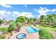 Overhead view of pool and hot tub area surrounded by lounge chairs, playground and lush landscaping at 745 N Royal Crest Cir # 141, Las Vegas, NV 89169