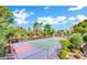 Overhead view of tennis and basketball courts surrounded by trees and lush greenery with a city view at 745 N Royal Crest Cir # 141, Las Vegas, NV 89169